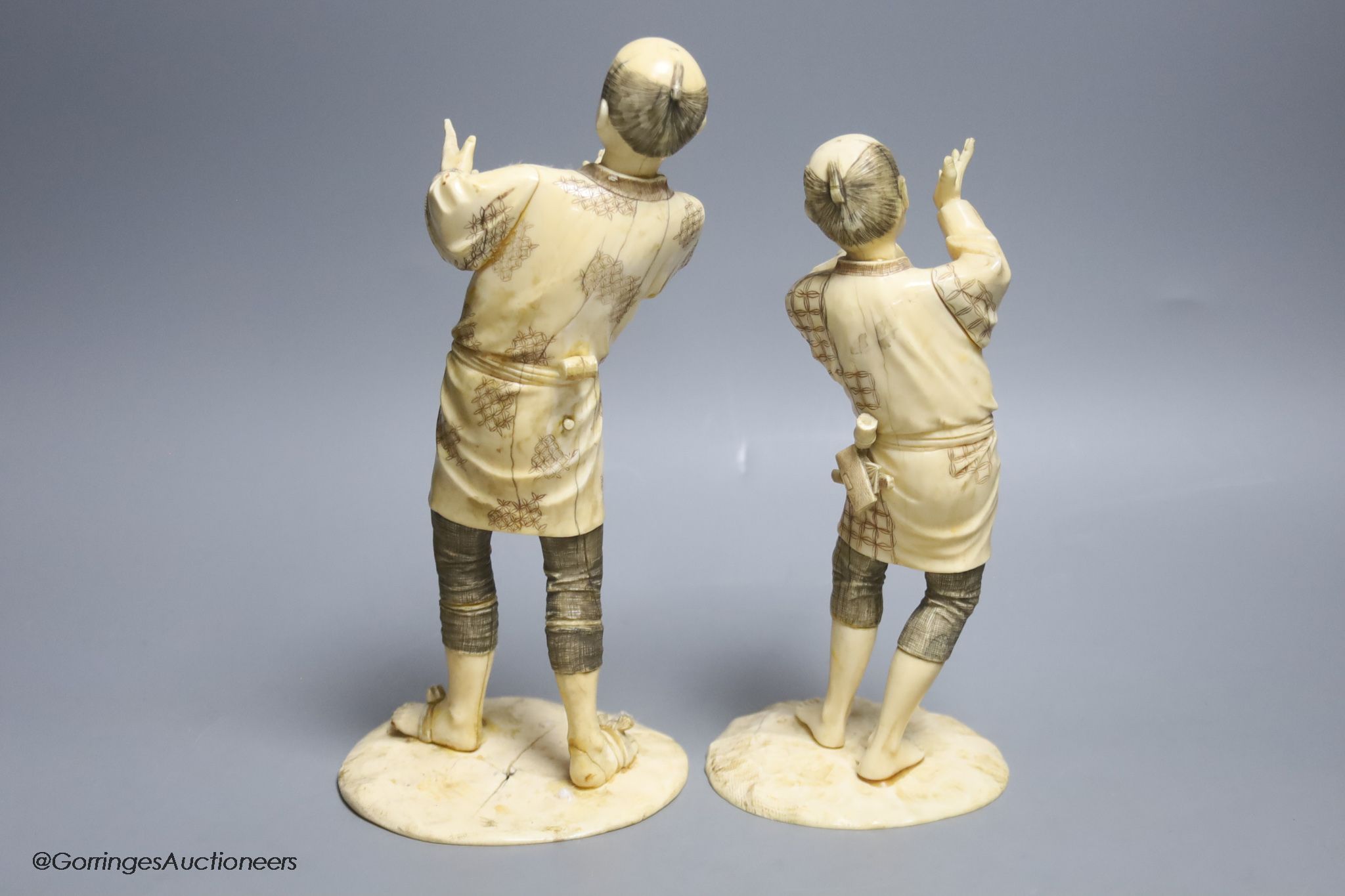 Two Japanese sectional ivory figures of farmers, early 20th century, one signed to base, height 24cm